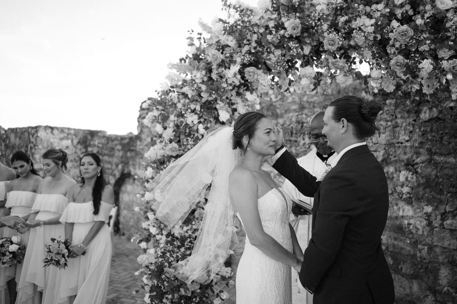 Black and white photo of a bride and groom together during their vows at their wedding ceremony at the Hilton Hotel in Barbados