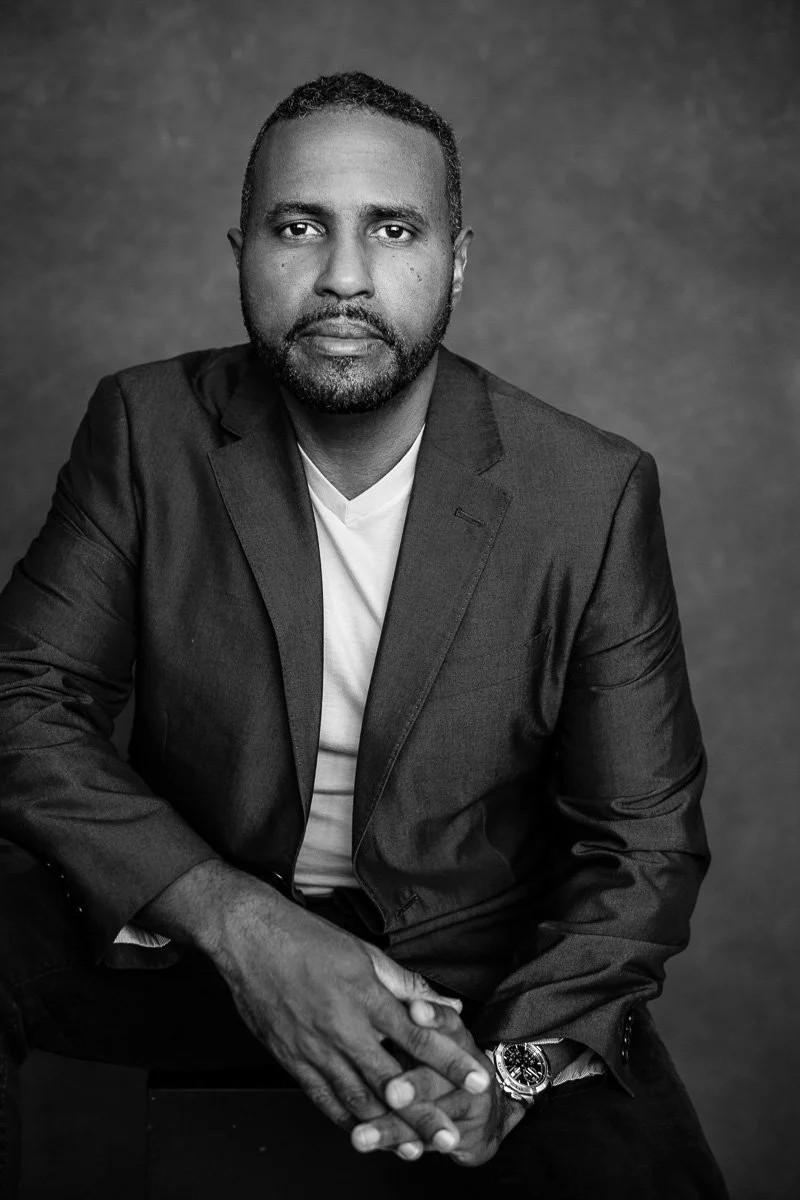 man photographed in a black and white photo during a headshot session by Aniya Emtage in Barbados