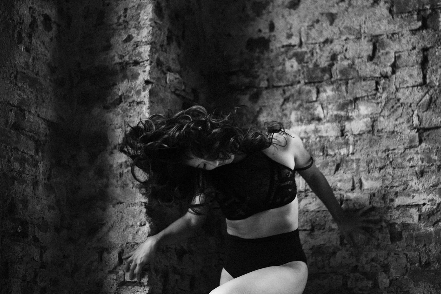 Aniya Emtage Photography photographs woman with hair movement in boudoir session. 