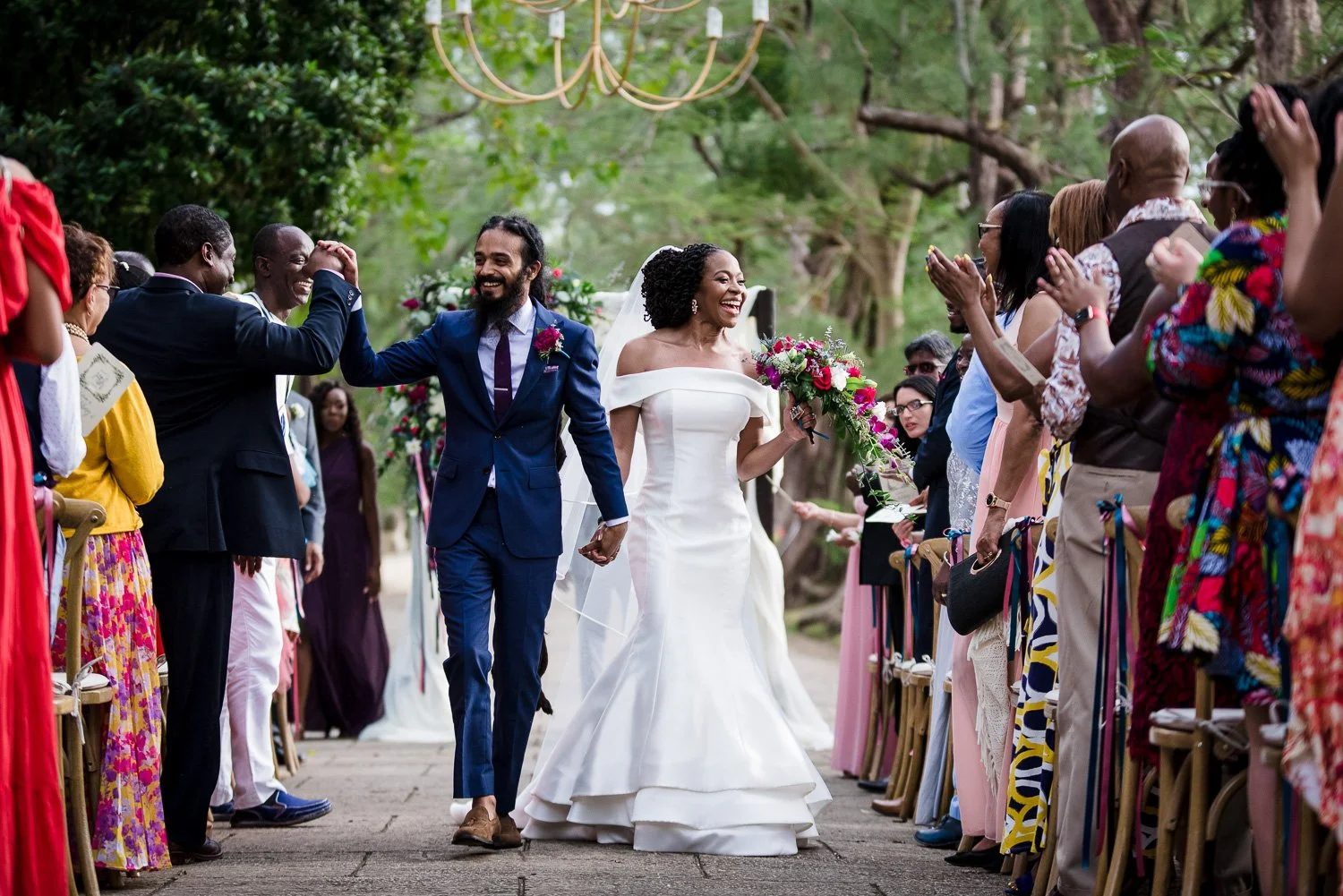 Couple walk down the aisle after the wedding ceremony at Halton Great House in Barbados. Photo by Aniya Emtage