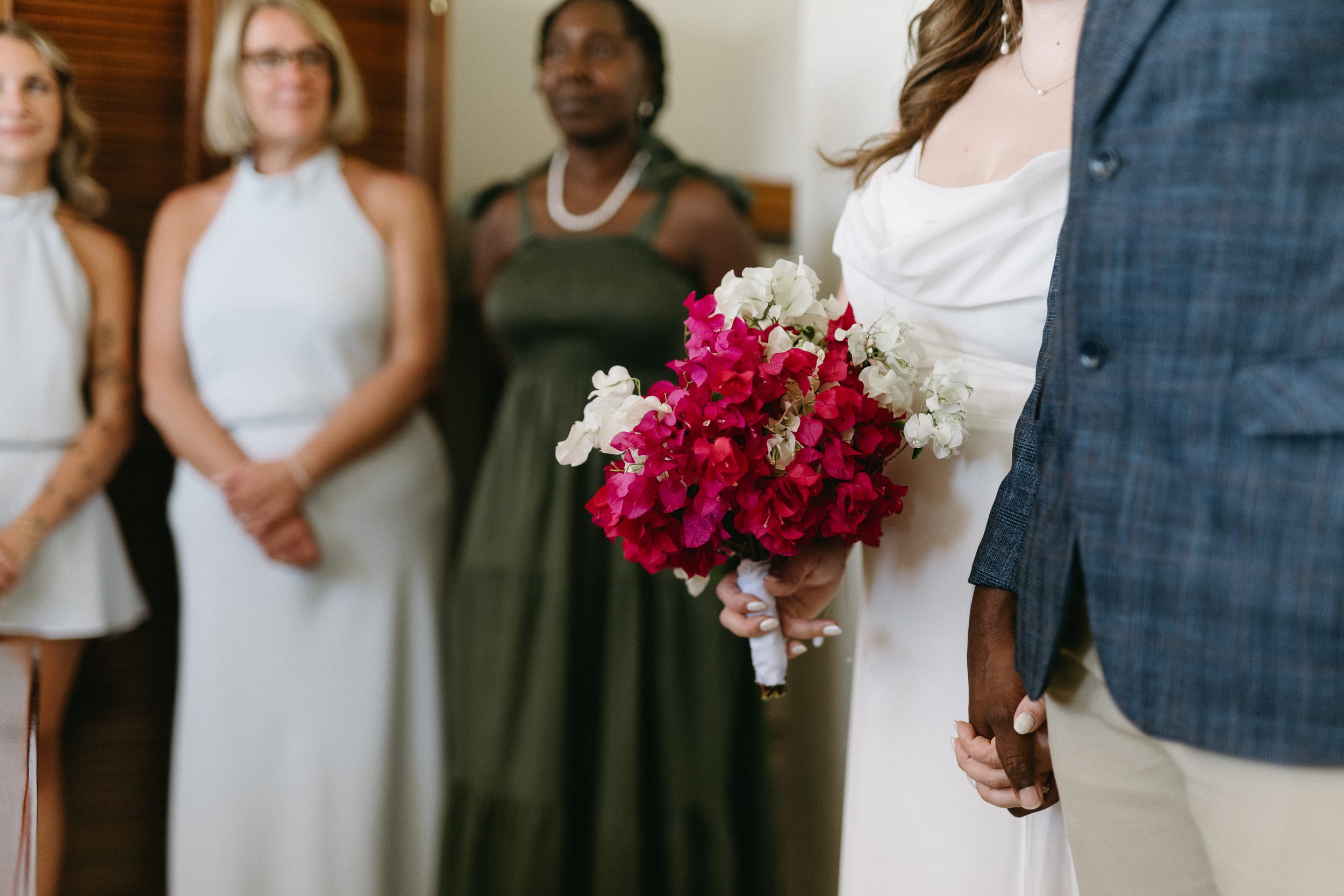photo of a brides floral bouquet and guests at their barbados courthouse wedding