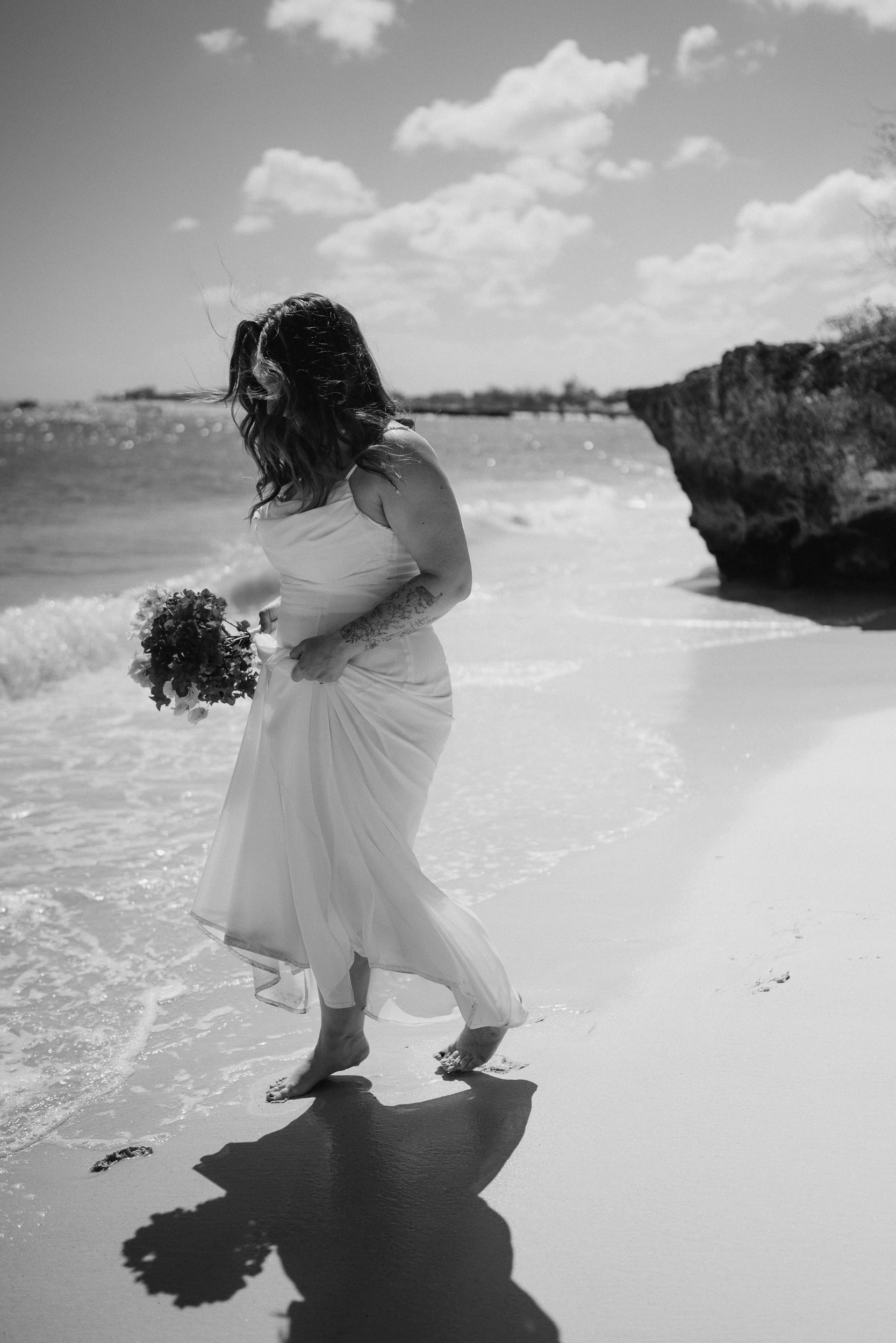 Bride splashing around in the beach