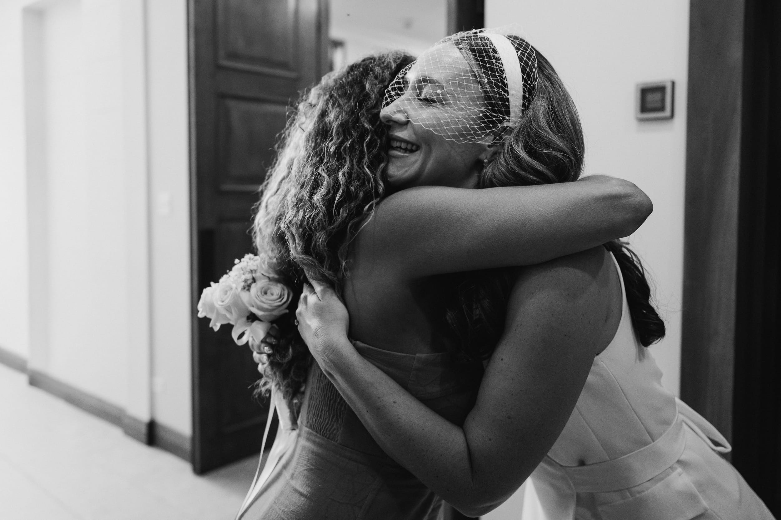 Bride and friend share a hug before her Barbados Courthouse Wedding