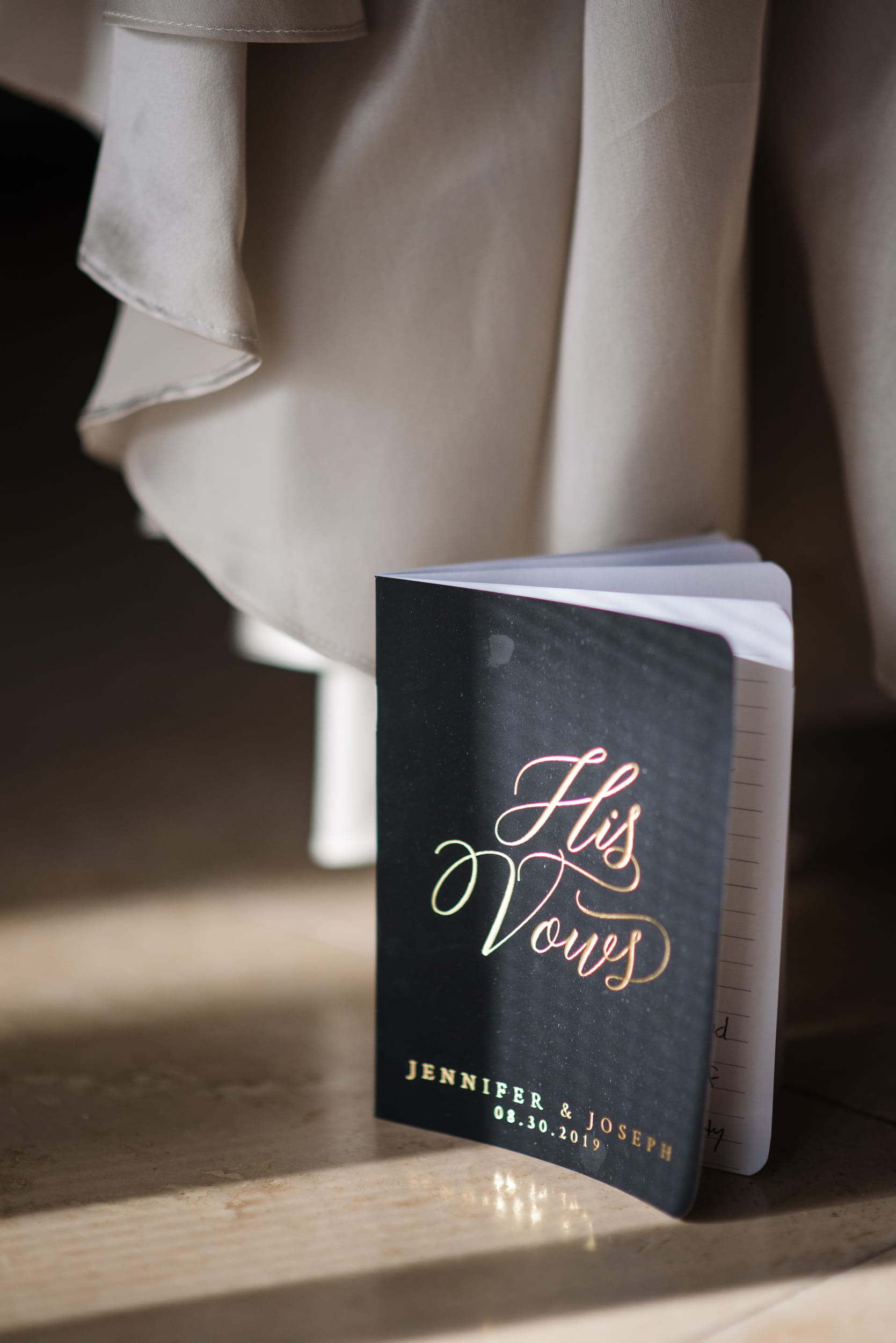 vow book next to the wedding dress