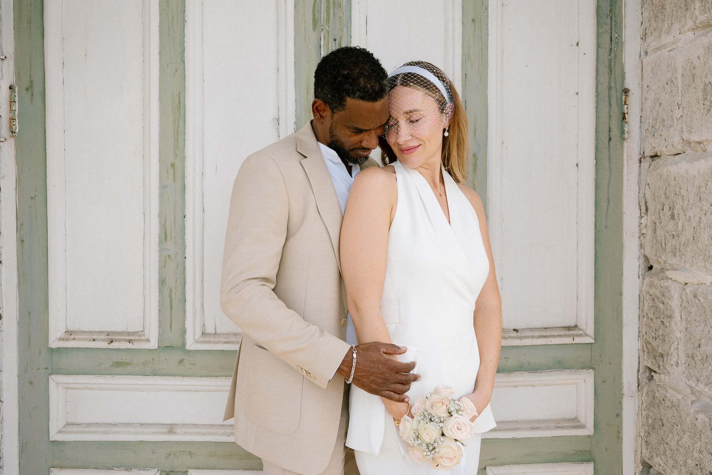 couple share an embrace after their barbados courthouse wedding