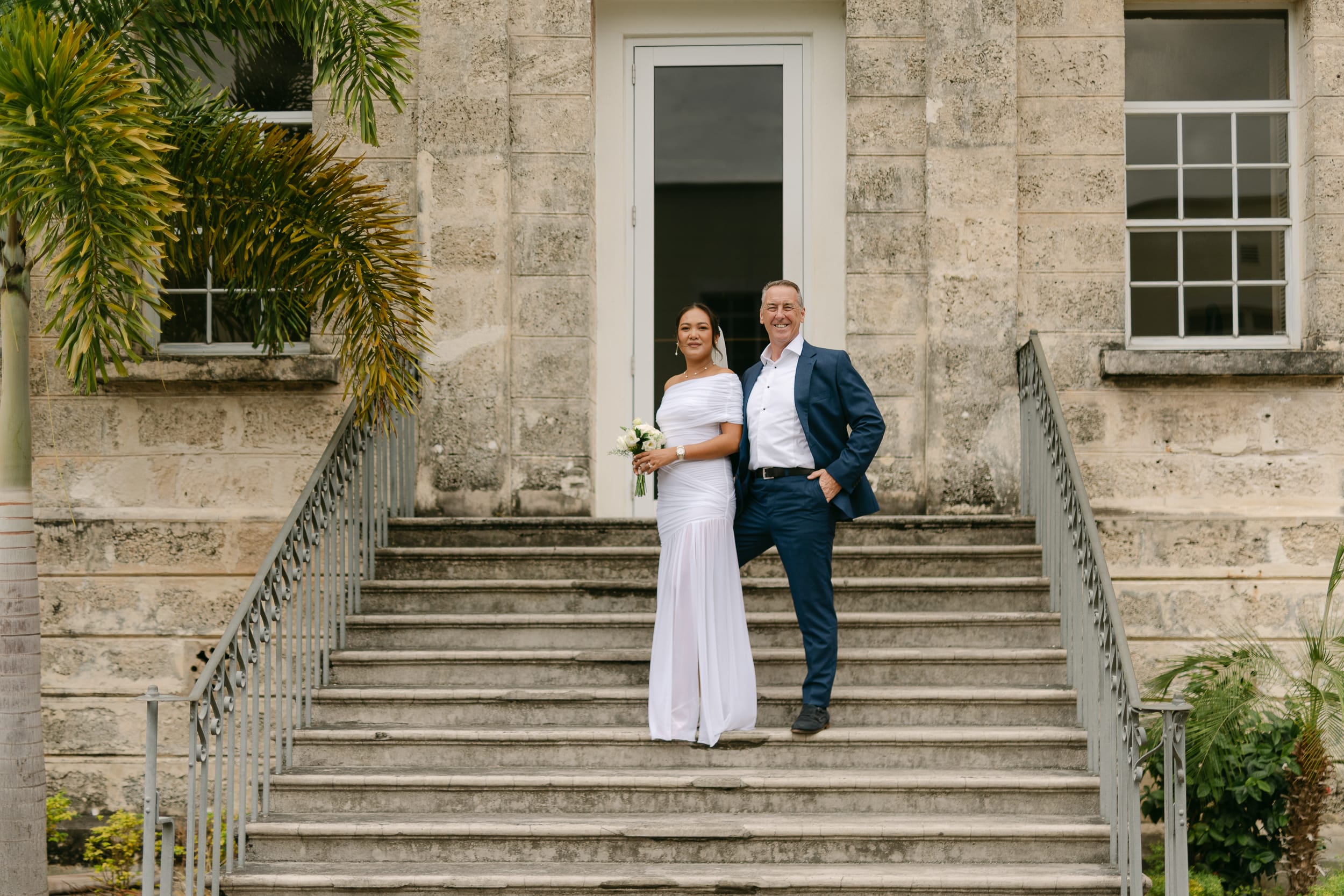 Couple together on the stairs after their Barbados Courthouse Wedding