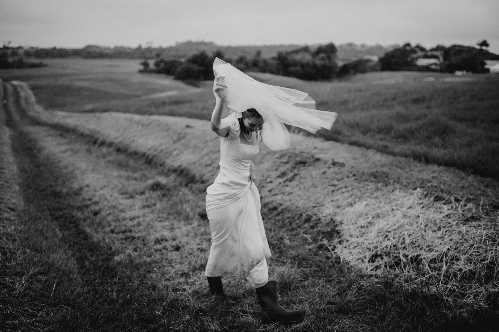 bride holding her veil in the wind