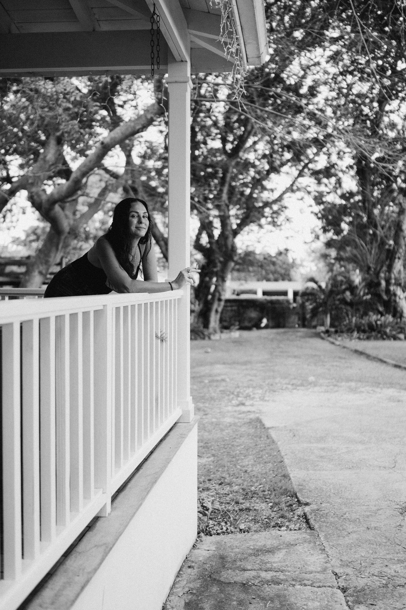 mom leaning over the balcony with a cigarette