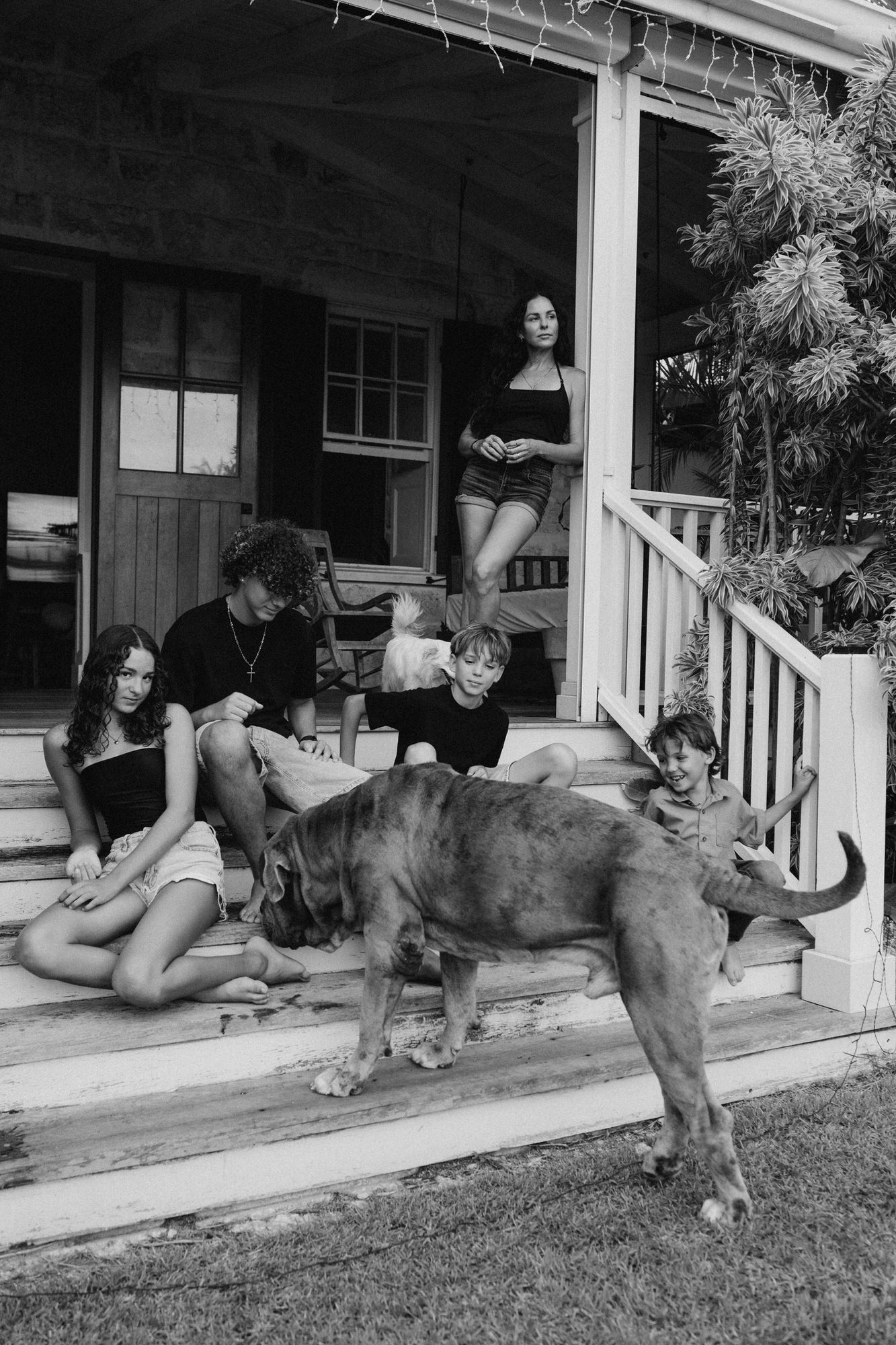 mom with her 4 kids on a wooden patio