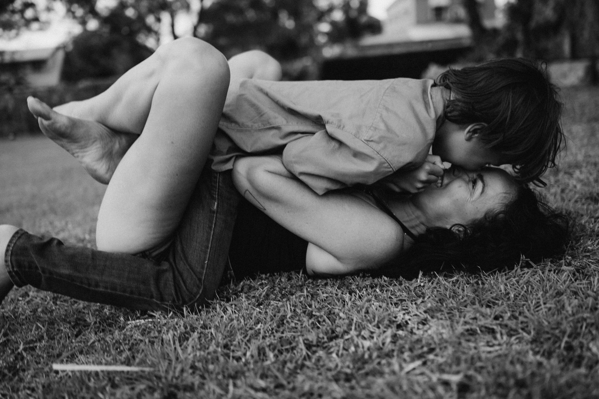 mom and sun snuggling on the grass