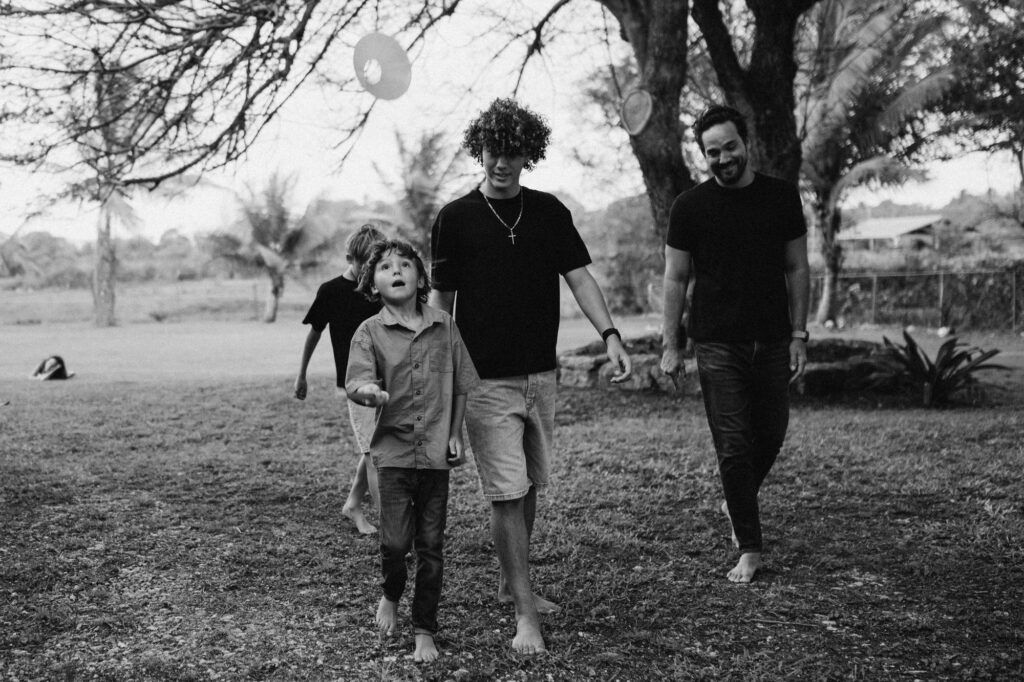 dad and 3 sons walking together