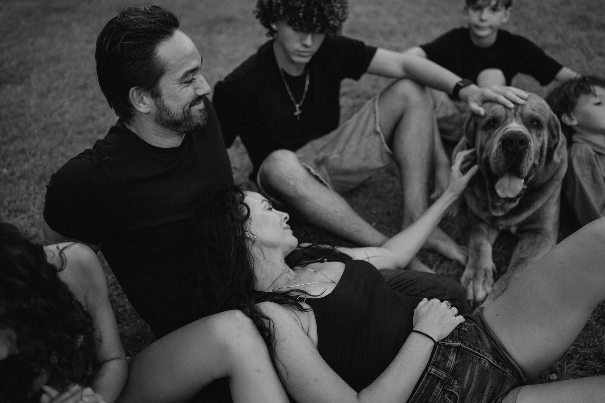 family lying together with their dog