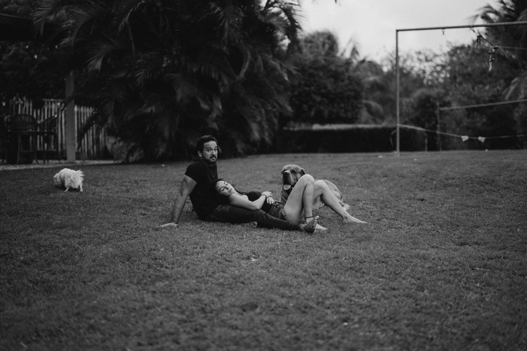 mom lying in dads lap on the grass