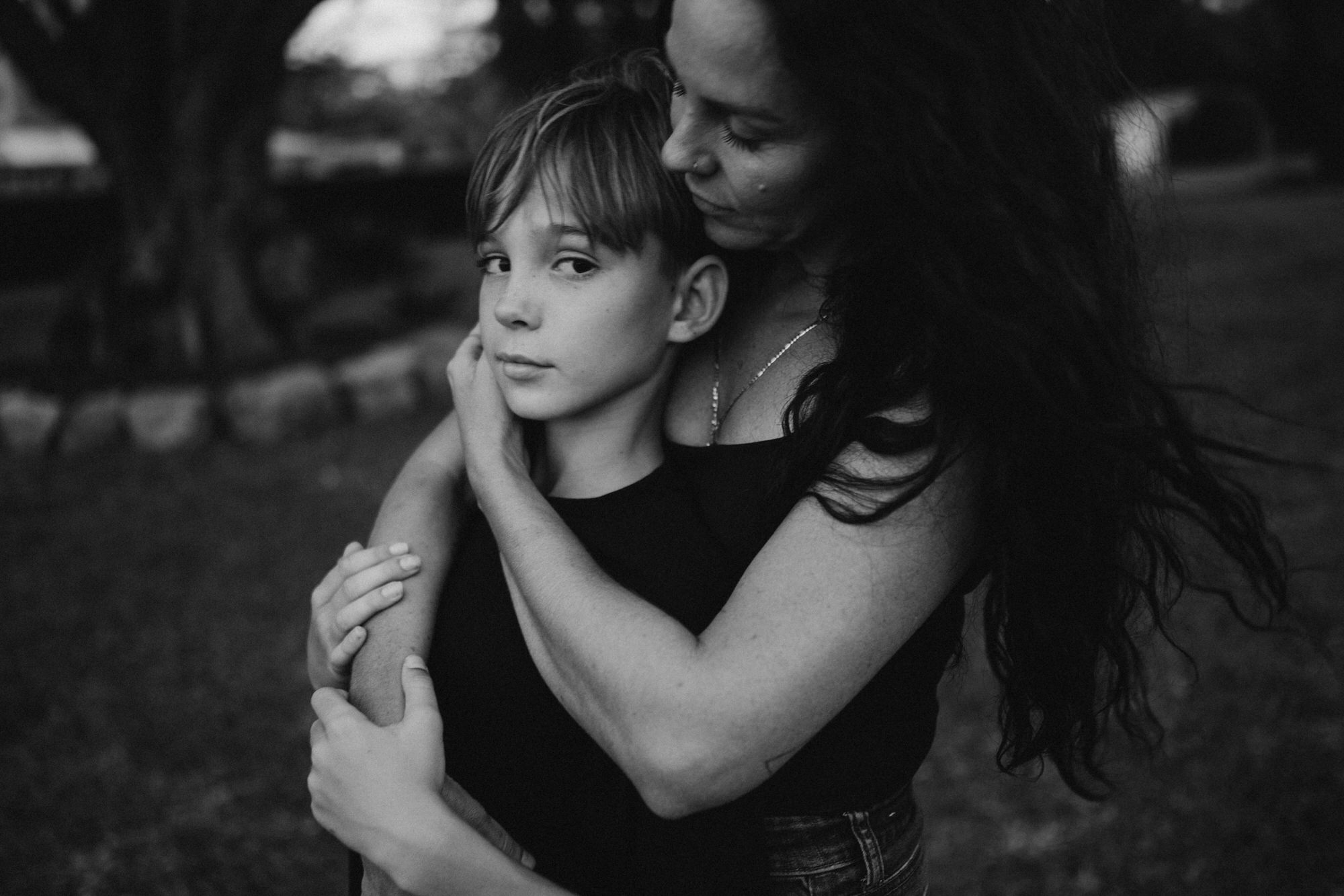 mom and son together as she holds his face
