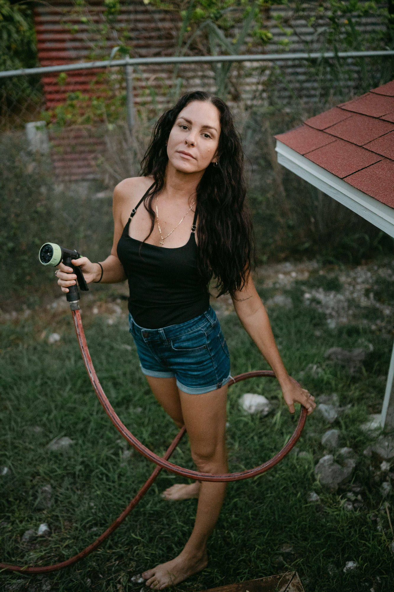 portrait of a mom watering her garden